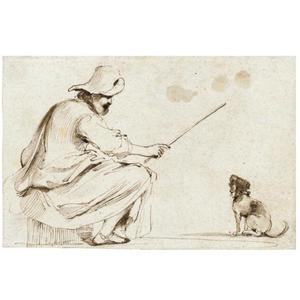 A seated man training a dog
