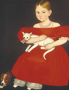 niña joven con un gato y perro