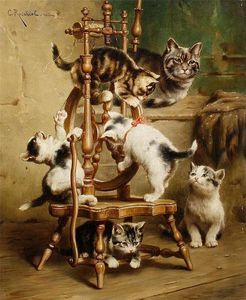 Kittens playing on a spinning wheel