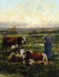 Un Pastorella con le mucche e pecore in un paesaggio