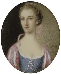 A Young Lady In Blue Dress With Pearls At Corsage