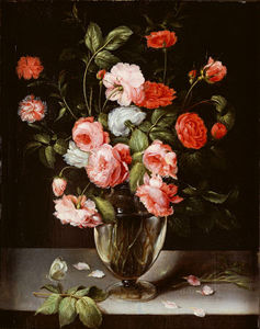 Roses And Carnations In A Glass Vase On A Stone Ledge
