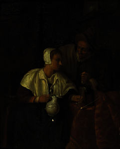 A woman seated by a table pouring wine for a man, in an interior