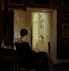 A woman seated near a door