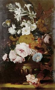 Roses, jasmine, primroses and other flowers in an urn on a table top