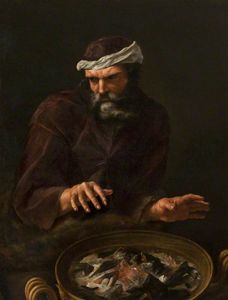 A bearded man warming his hands