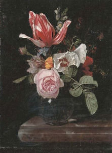 Roses, peonies, a tulip and other flowers in a glass vase on a stone ledge