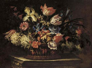 Tulips, irises, daffodils, poppies and other flowers in a basket on a plinth