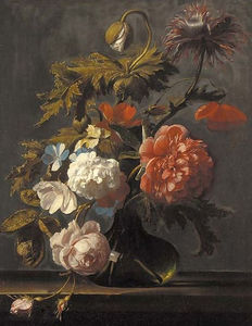 Tulips, roses, peonies, poppies and other flowers in a glass vase on a ledge