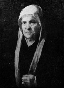 Portrait einer alten Frau mit einem Rosenkranz.