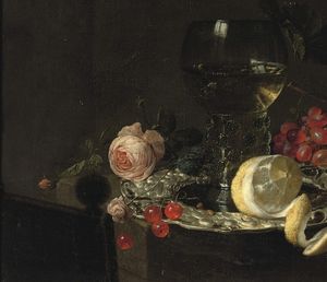 A 'Roemer' with white wine, a partially peeled lemon, cherries and other fruit on a silver plate with a rose and grapes on a stone ledge