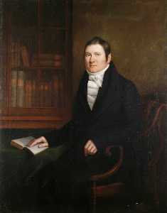 Portrait of a Man Sitting at a Table with an Open Book